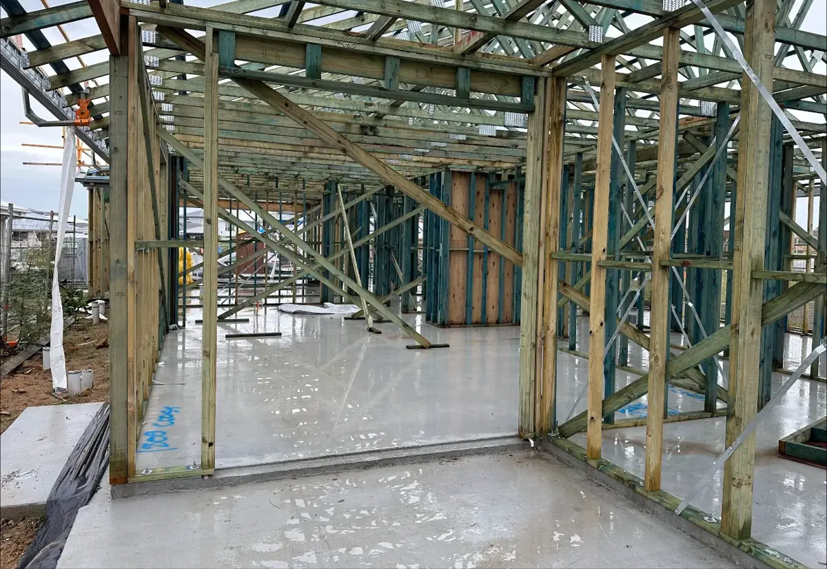 Timber wall frames and roof trusses on the slab
