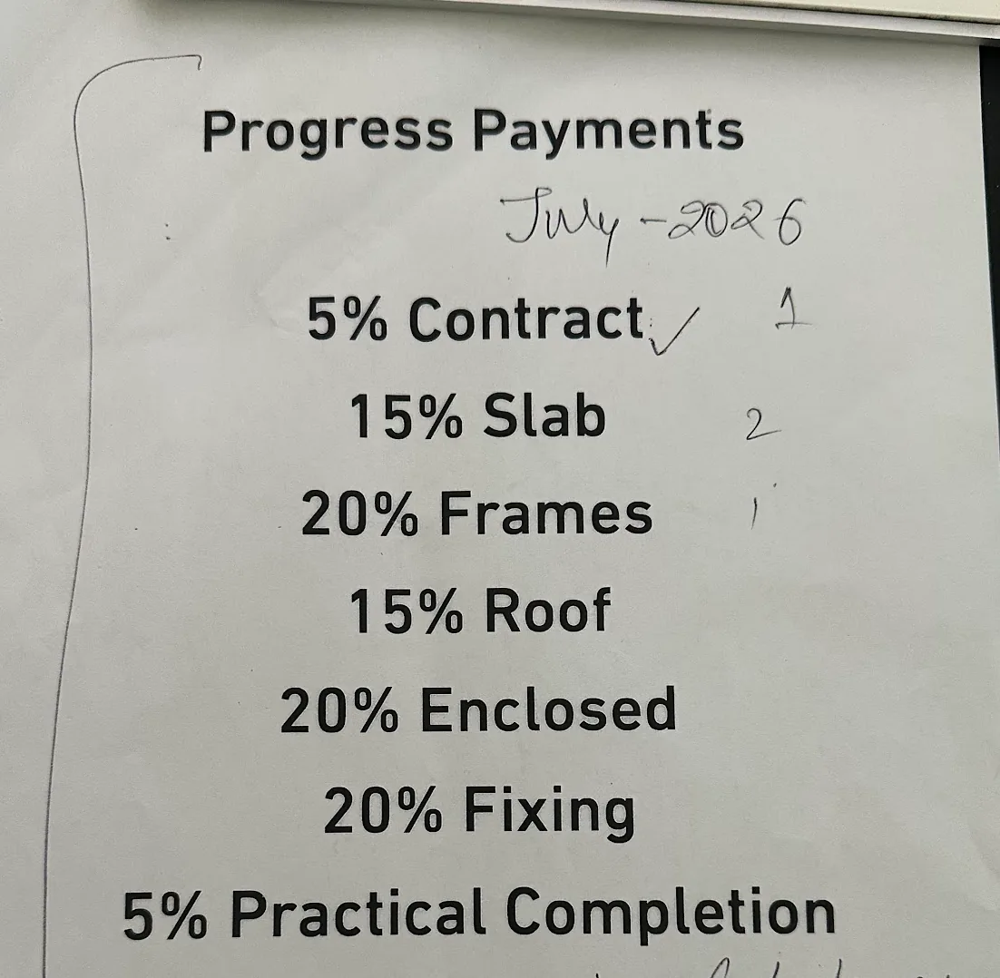 A printed progress payment schedule with handwritten ticks