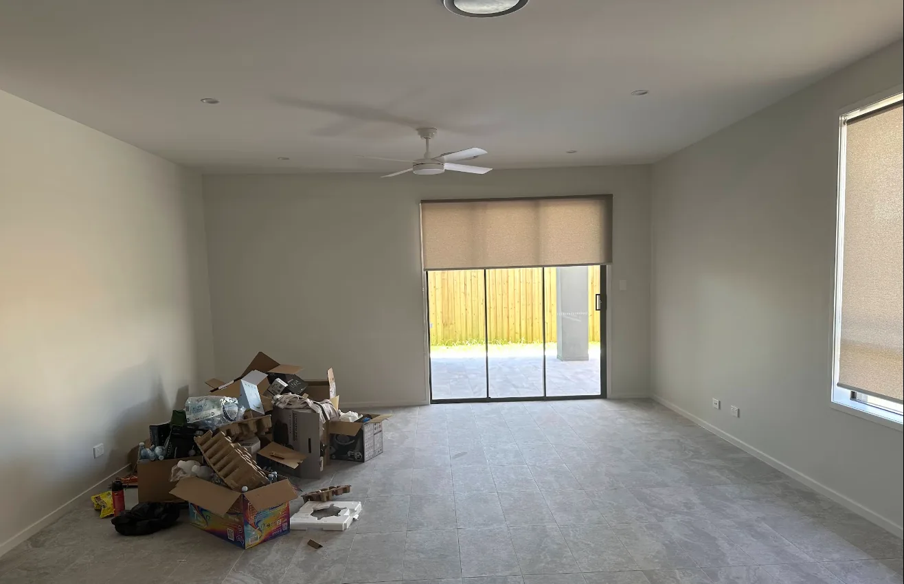 Living room with roller blinds on the sliding door and window