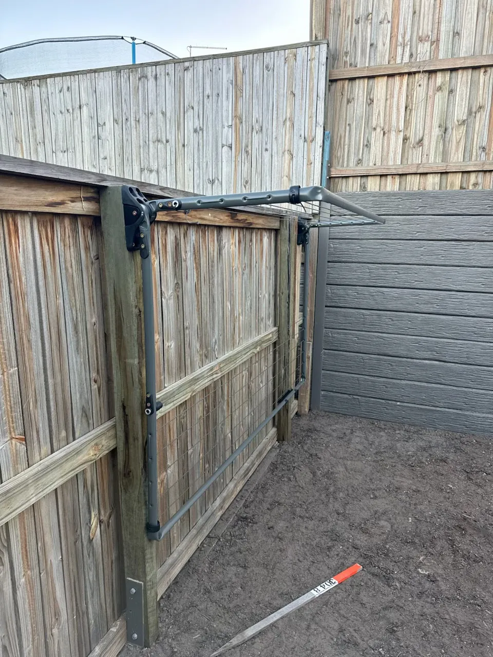 A fold-down clothesline on a timber fence
