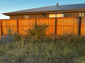 A lapped and capped timber fence