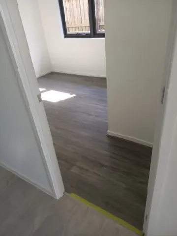 A bedroom with new hybrid timber-look flooring