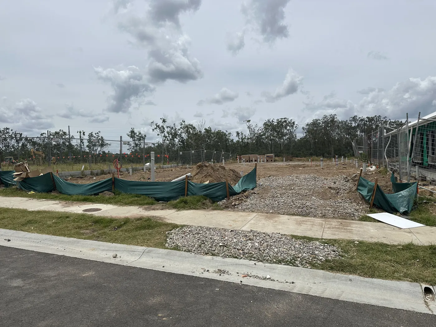 A cleared residential lot with silt fence in a new estate