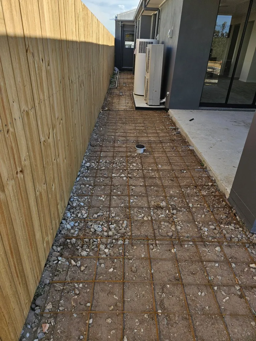 Mesh laid along a fence line for a path